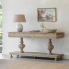 Wooden console table with decorative items in a room setting