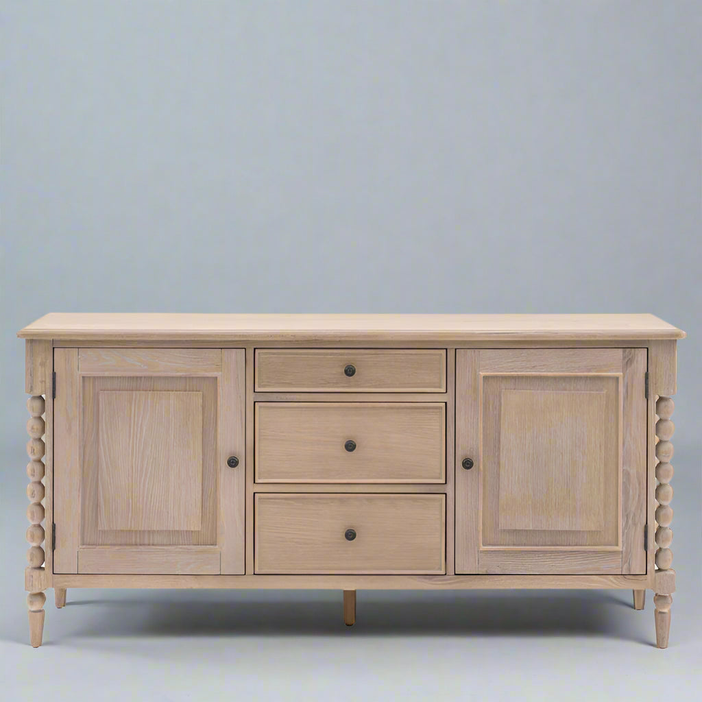 Wooden sideboard with three doors and three drawers on a white background
