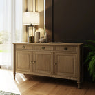 Wooden sideboard with decorative items in a room with a window and plant