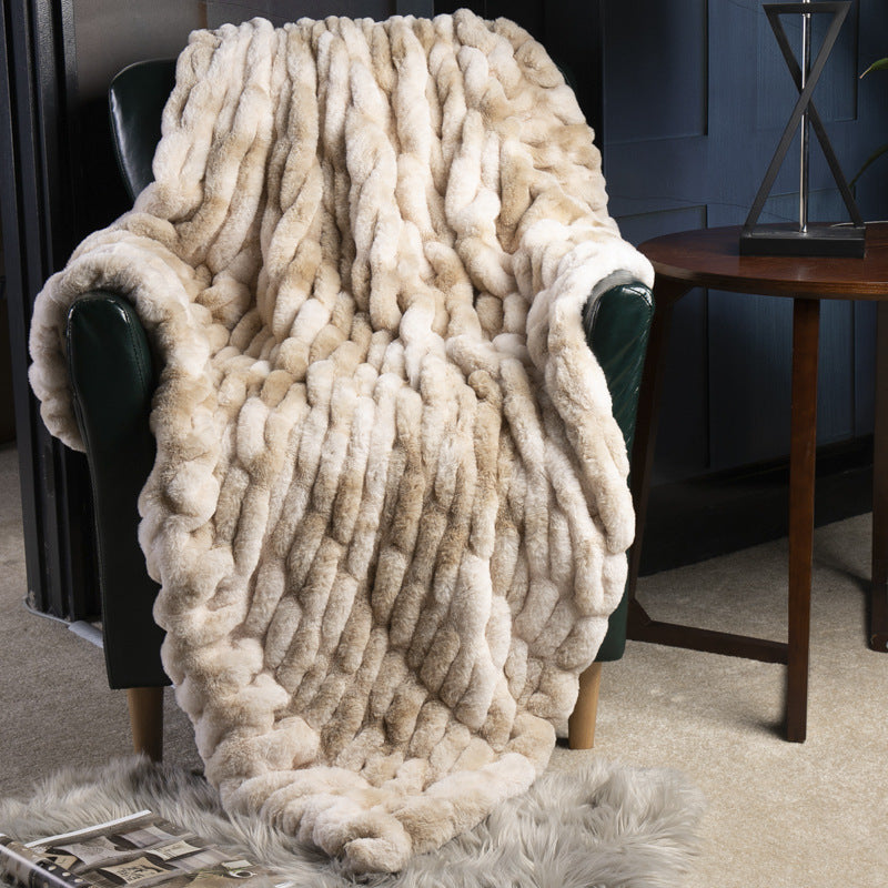 Cozy beige blanket draped over a chair in a home setting